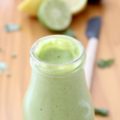 Green Dressing in bottle, limes and lemon in background