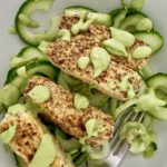 Green Tahini Avocado Dressing drizzled over temps and cucumbers.